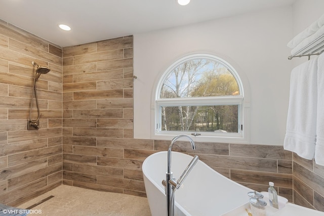 full bath featuring a freestanding tub, recessed lighting, and tiled shower