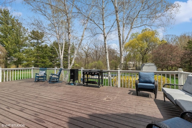 wooden deck featuring a storage shed, an outdoor structure, and an outdoor hangout area