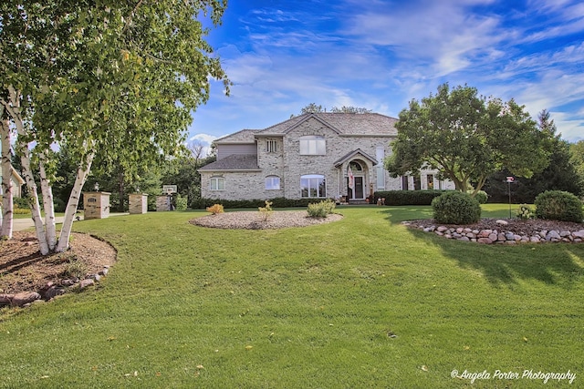 french country style house with a front yard