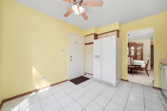 interior space with baseboards and a ceiling fan