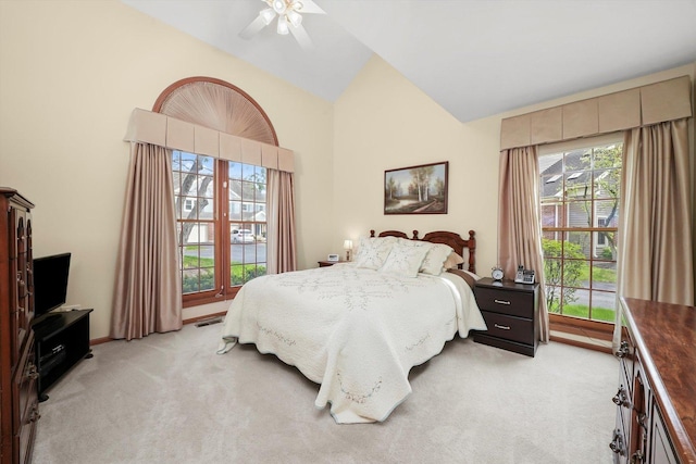 bedroom with visible vents, ceiling fan, light carpet, and high vaulted ceiling