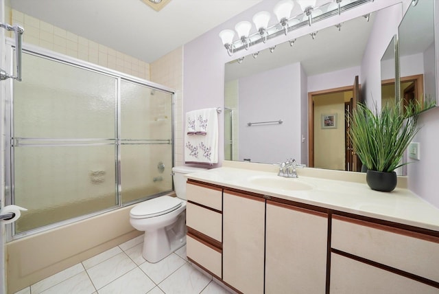full bathroom with tile patterned flooring, shower / bath combination with glass door, toilet, and vanity