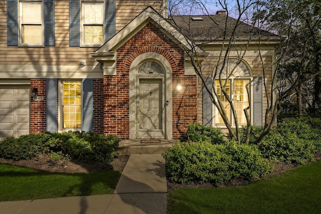 property entrance featuring brick siding