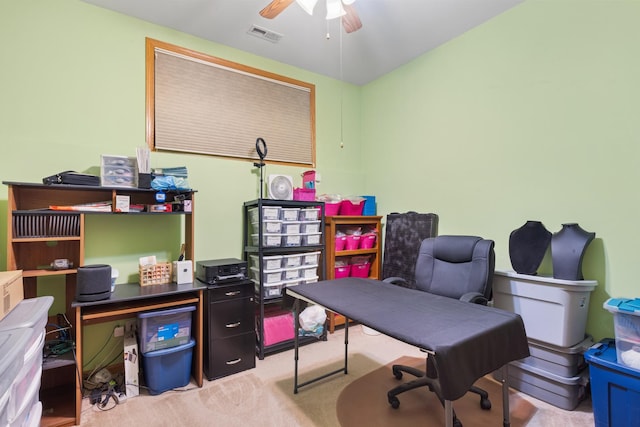 office area with carpet floors, visible vents, and ceiling fan