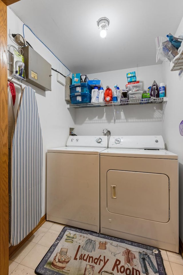 clothes washing area featuring light tile patterned flooring, laundry area, and independent washer and dryer