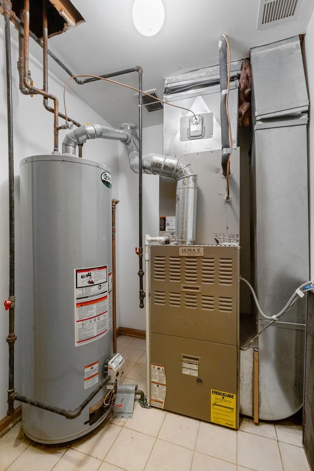 utility room with visible vents and water heater