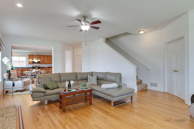 1330 Horizon Trl, Wheeling, IL 60090 - living area with visible vents, light wood-style flooring, ceiling fan, and stairway