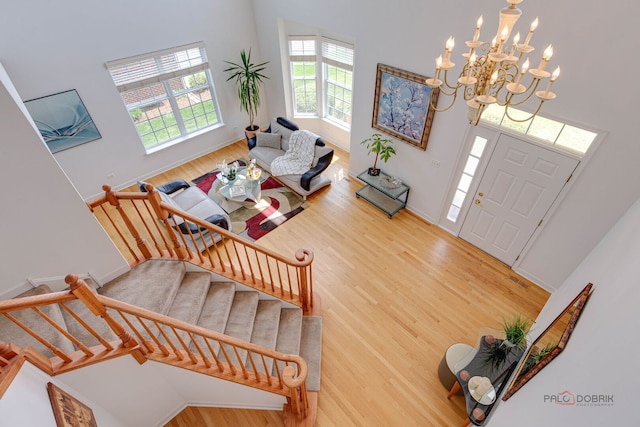 1330 Horizon Trl, Wheeling, IL 60090 - entryway with wood finished floors, baseboards, a high ceiling, stairway, and a chandelier
