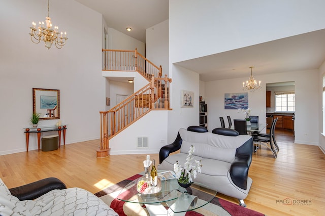 1330 Horizon Trl, Wheeling, IL 60090 - living room featuring an inviting chandelier, light wood finished floors, visible vents, and stairway