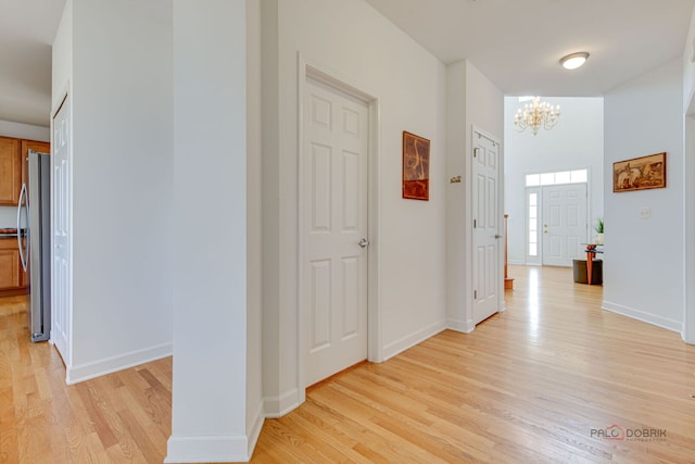 1330 Horizon Trl, Wheeling, IL 60090 - corridor featuring light wood-type flooring, baseboards, and an inviting chandelier