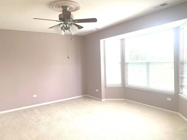 644 Tuscan Vw, Elgin, IL 60124 - spare room featuring light colored carpet, a ceiling fan, and plenty of natural light