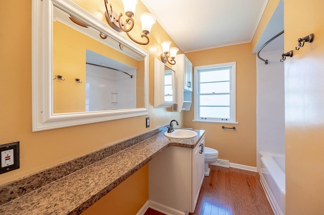 751 Cedar Ln, Chicago Heights, IL 60411 - full bathroom featuring vanity, toilet, crown molding, baseboards, and wood finished floors