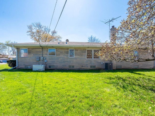 751 Cedar Ln, Chicago Heights, IL 60411 - rear view of property with central AC, a chimney, a lawn, and stone siding