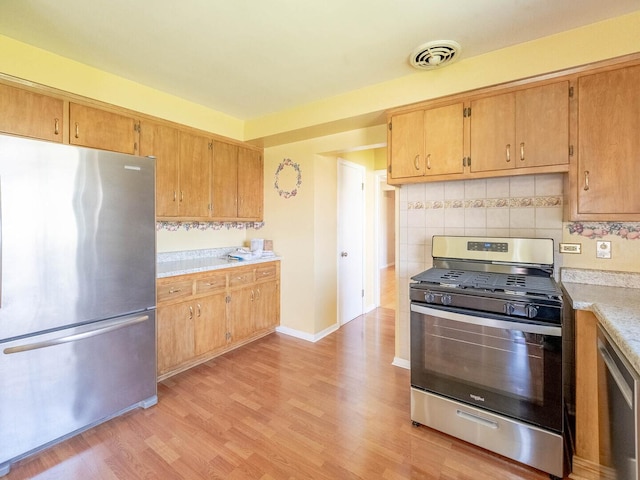 751 Cedar Ln, Chicago Heights, IL 60411 - kitchen with light wood finished floors, visible vents, stainless steel appliances, and light countertops