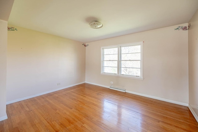 751 Cedar Ln, Chicago Heights, IL 60411 - empty room with a baseboard radiator, light wood-type flooring, and baseboards