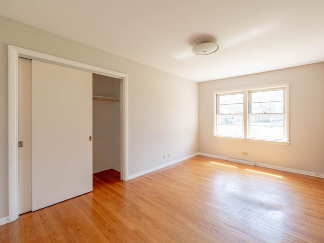 751 Cedar Ln, Chicago Heights, IL 60411 - unfurnished bedroom featuring visible vents, baseboards, light wood finished floors, and a closet