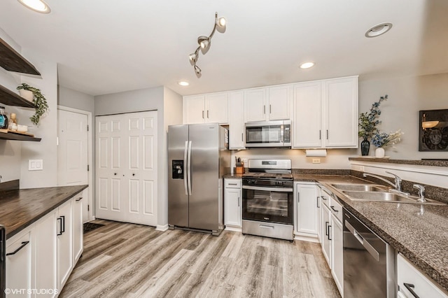 3095 Courtland St Unit 0, Woodstock, IL 60098 - kitchen with stainless steel appliances, dark countertops, white cabinetry, and a sink