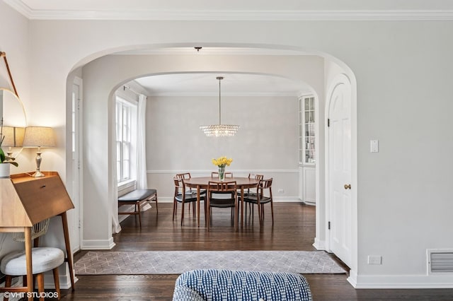 1404 Lincoln St, Evanston, IL 60201 - dining space with wood finished floors, visible vents, ornamental molding, arched walkways, and baseboards