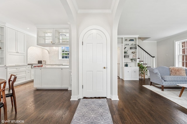 1404 Lincoln St, Evanston, IL 60201 - entryway featuring stairway, arched walkways, crown molding, and dark wood-style floors