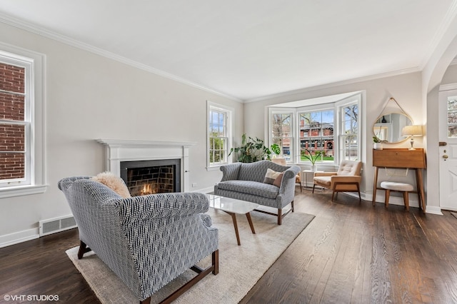 1404 Lincoln St, Evanston, IL 60201 - living area featuring dark wood-style flooring, baseboards, visible vents, crown molding, and a lit fireplace