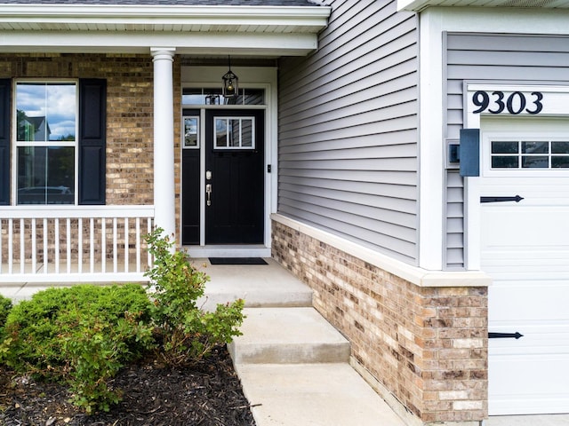 9303 Enstrom Ln, Huntley, IL 60142 - entrance to property with brick siding, roof with shingles, and a garage
