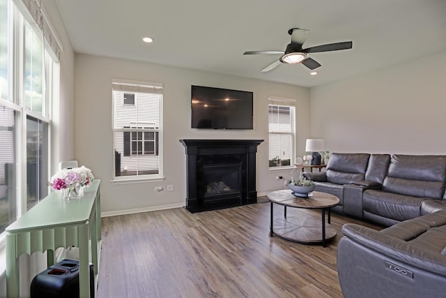 9303 Enstrom Ln, Huntley, IL 60142 - living room with wood finished floors, a ceiling fan, a fireplace with flush hearth, and recessed lighting