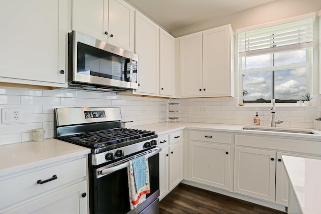 9303 Enstrom Ln, Huntley, IL 60142 - kitchen featuring stainless steel appliances, white cabinetry, tasteful backsplash, and dark wood-type flooring