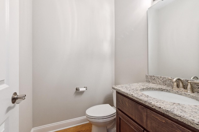 9356 Parkwood Ln, Tinley Park, IL 60487 - bathroom with vanity, toilet, baseboards, and wood finished floors