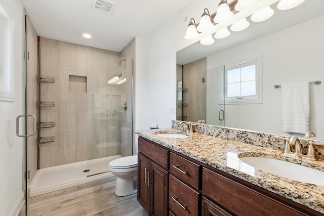 9356 Parkwood Ln, Tinley Park, IL 60487 - bathroom with a shower stall, toilet, double vanity, and wood finished floors
