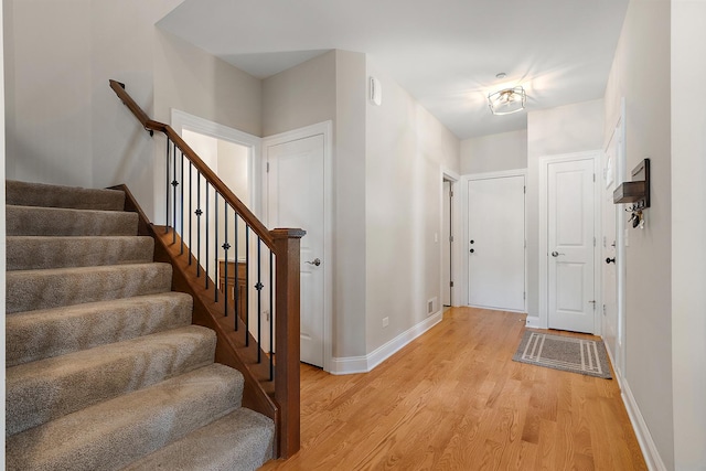 9356 Parkwood Ln, Tinley Park, IL 60487 - foyer entrance featuring light wood-style flooring, baseboards, and stairs