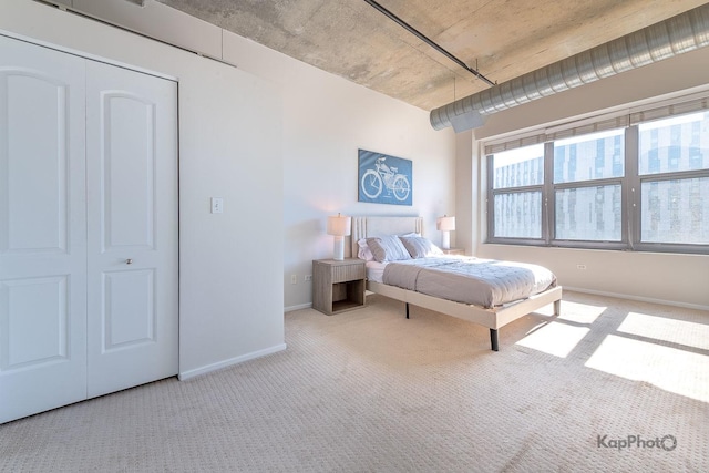 bedroom with baseboards and carpet