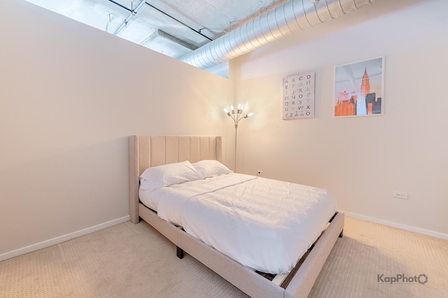carpeted bedroom featuring baseboards
