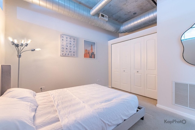 bedroom with light carpet, visible vents, and a closet