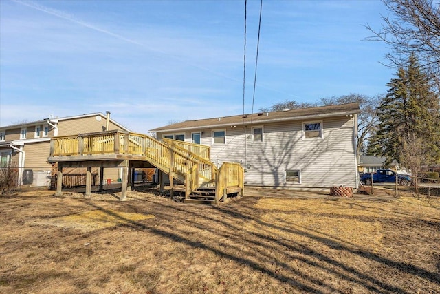 back of property featuring stairway, a wooden deck, and fence