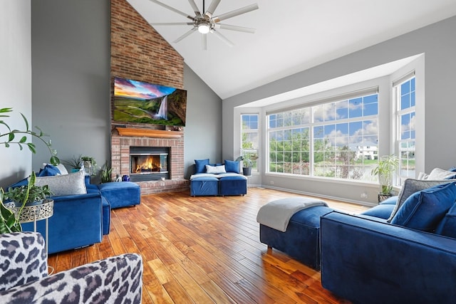 living room featuring a brick fireplace, a ceiling fan, high vaulted ceiling, and hardwood / wood-style flooring