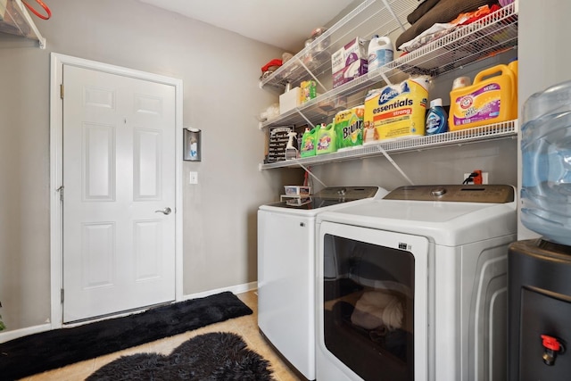 laundry room featuring baseboards, laundry area, and washer and dryer
