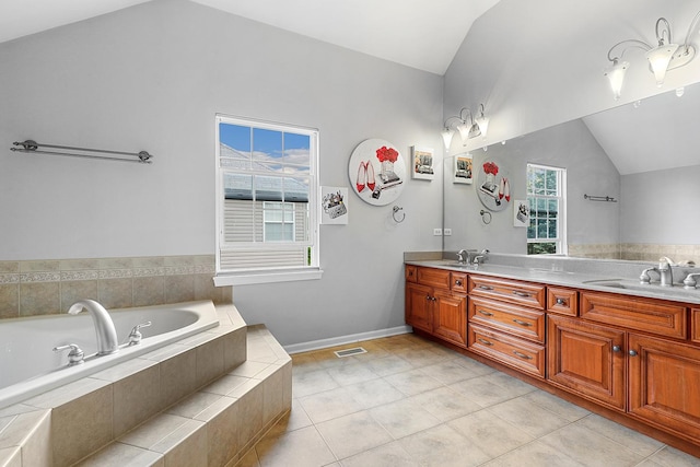 bathroom with tile patterned flooring, double vanity, a garden tub, a sink, and vaulted ceiling