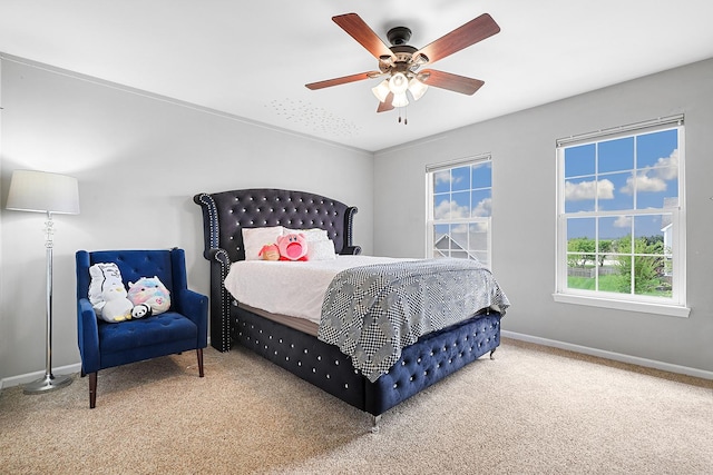 bedroom featuring baseboards, ceiling fan, and carpet