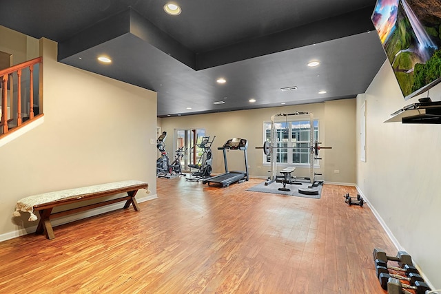 gym with baseboards, recessed lighting, and wood finished floors