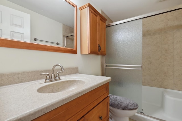 full bath featuring vanity, an enclosed shower, and toilet
