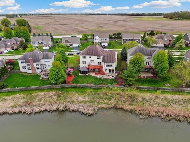 drone / aerial view featuring a residential view and a water view