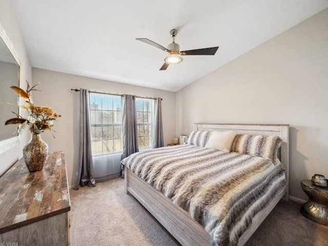 bedroom with lofted ceiling, a ceiling fan, light carpet, and baseboards