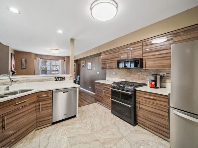 kitchen featuring brown cabinets, stainless steel appliances, and a sink