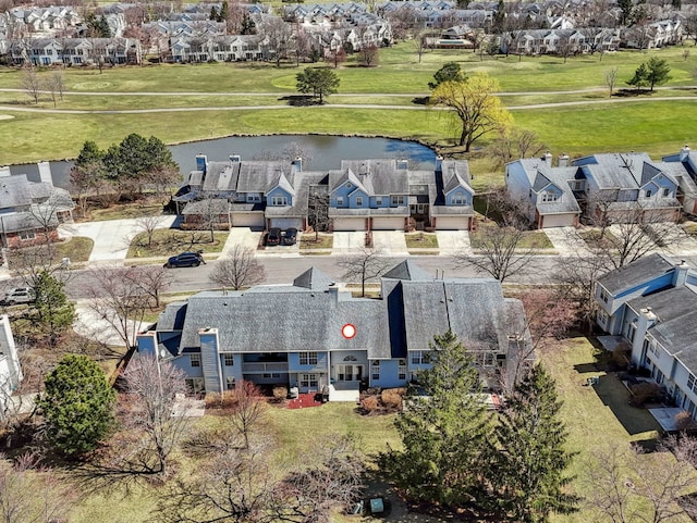 drone / aerial view featuring a residential view and a water view