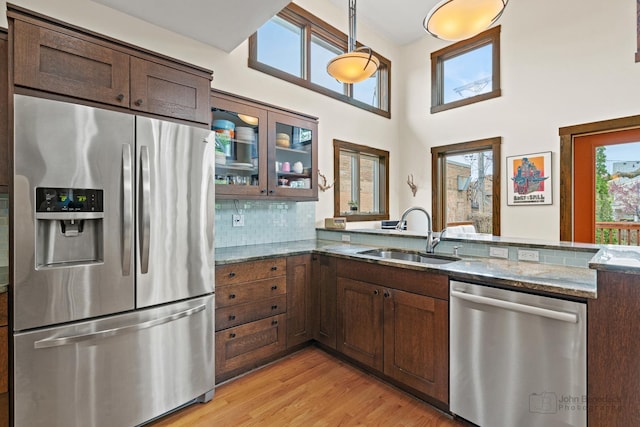 9515 S Damen Ave, Chicago, IL 60643 - kitchen with a sink, stainless steel appliances, decorative backsplash, stone counters, and glass insert cabinets