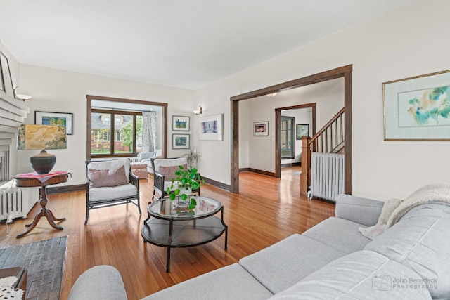9515 S Damen Ave, Chicago, IL 60643 - living area featuring a fireplace, stairway, baseboards, light wood finished floors, and radiator