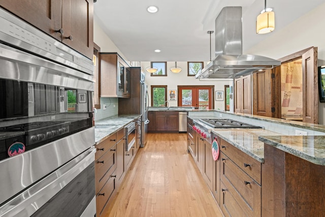 9515 S Damen Ave, Chicago, IL 60643 - kitchen featuring appliances with stainless steel finishes, light stone counters, a sink, light wood finished floors, and island range hood