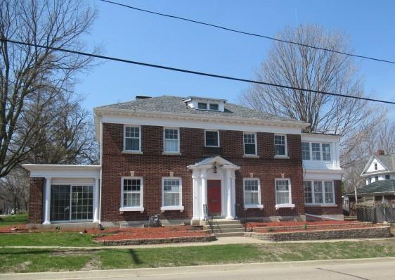 colonial inspired home with brick siding