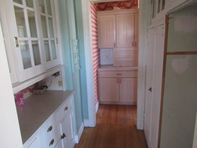 hallway with baseboards and light wood finished floors