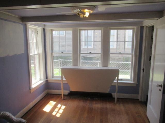dining area with baseboards and wood finished floors